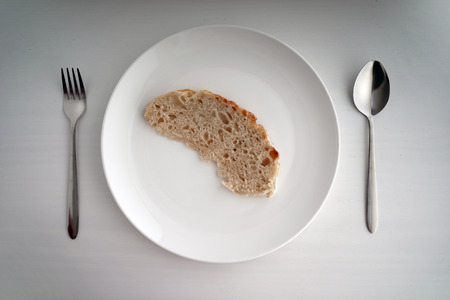 top view of a single piece of bread with utensilsの写真素材