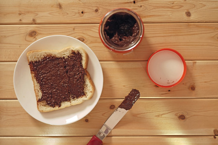 Serving breakfast with peanut butter topping on white breadの写真素材