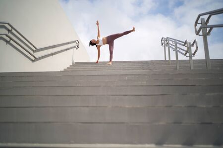 yoga in public open spaces, asian chinese lady doing Yoga on stairsの写真素材