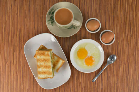 daily breakfast in Singapore, Malaysia and Indonesia consist of toasted bread and kaya and egg with coffee or tea in the morning. This can be found commonly in coffeeshopsの写真素材