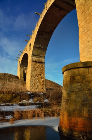 The ruins bridge in Caucasus of sunny dayの写真素材