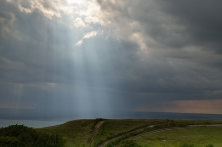The sunny ray in Caucasus sky of summerの写真素材