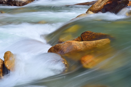 This is red stones in Caucasus river in springの写真素材