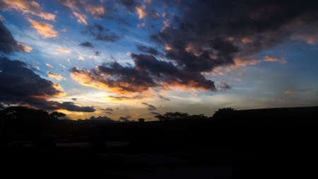 Urban sky in its sunset with blue and orange colors, many cloudsの写真素材