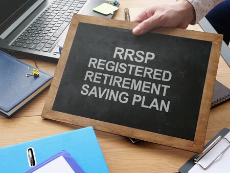 Writing note shows the text RRSP Registered Retirement Saving Planの写真素材