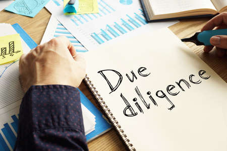Due diligence is shown on the conceptual business photoの写真素材