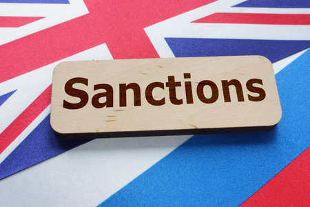 Sanctions are shown by the text with Britain flag and russian flag under itの写真素材