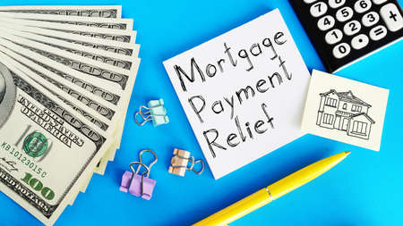 Mortgage payment relief is shown on a photo using the text and dollarsの写真素材