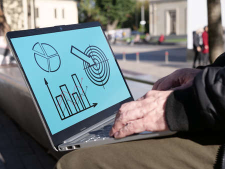 Market research is shown using the graphs on a monitor of laptopの写真素材