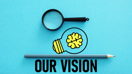 Our Vision is shown using the text and photo of magnifier glass and picture of lampの写真素材