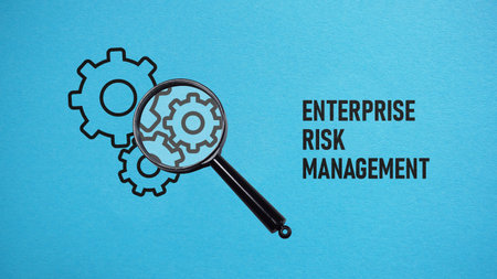 Enterprise Risk Management ERM is shown using a text and photo of magnifying glass and picture of gearsの写真素材