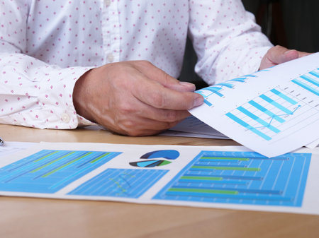 Auditor or financial inspector working on sales performance report at modern workplace. Business analyst checking in financial statement for audit. Accounting , Accountancy Conceptの写真素材