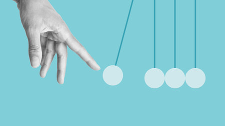 Hand launches pendulum balls. Start-up concept. Newton's cradle. Sphere hanging on threads. Launch Business Ideas Creativity Conceptの写真素材