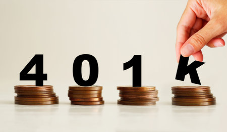 401k plan text stacked on coins as retirement savings concept