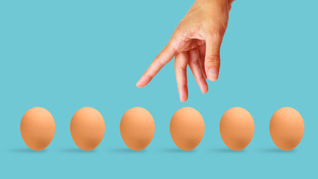 Diversification and risk management. Do not put all eggs in one basket. Collage with the hand which put eggs.の写真素材