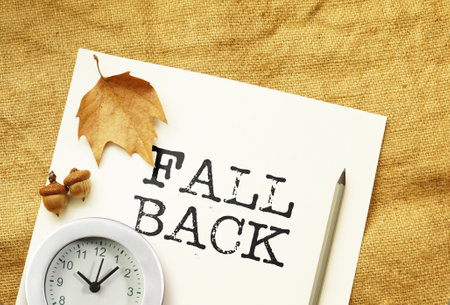 Fall back 1 hour time change is shown using a textの写真素材