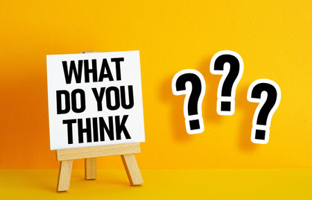 What do you think? text on paper card on orange backgroundの写真素材