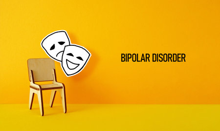 Bipolar disorder is shown with photo of happy and sad masksの写真素材