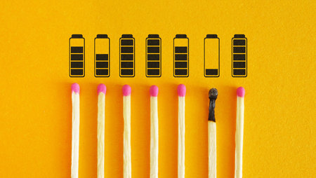 Working hard cause burnout, health problems and psychological exhaustion. Fatigue and powerlessness. Low battery indicator as symbol of depression, frustration and high workloadの写真素材