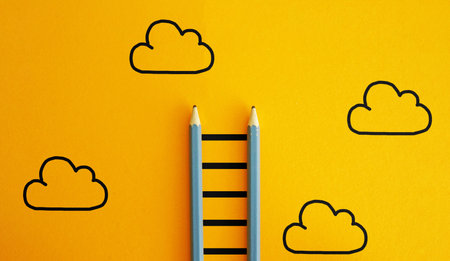 Ladder going forward into the sky with a group of clouds as a business symbol of financial freedom, career and aspirationsの写真素材