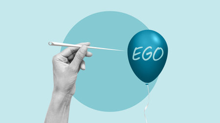 Ego destruction concept. Hand uses a needle to burst a balloon with word egoの写真素材