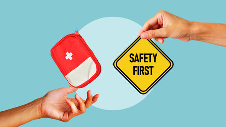 Safety first concept is shown by first aid kit with warning and information sign. Work safety, caution work hazards, danger surveillance and zero accidentの写真素材