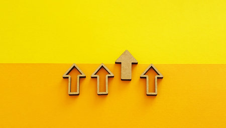 Wooden arrows pointing up on yellow background - business growth, leadership and competitive advantage conceptの写真素材