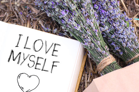 I love myself - motivational phrase is shown using a text and photo of flowers