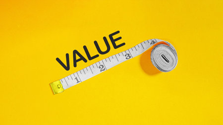 Value Evaluation Concept Using Measuring Tape. Business Growth, Metrics and Pricing on Yellow Backgroundの写真素材