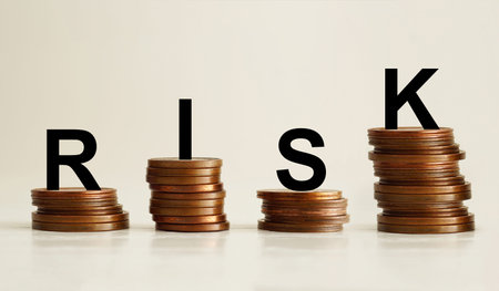 Risk brings money concept with rising stacks of coins and RISK word letters, financial decision...