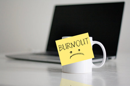 Burnout syndrome concept with exhausted remote worker workspace, stress, emotional fatigue and mental health issues in modern office environment, work overload and professional exhaustion