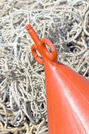 Red buoy with the networks of the fishermenの写真素材