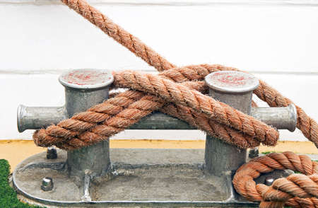 Red knotted rope on the bollardの写真素材