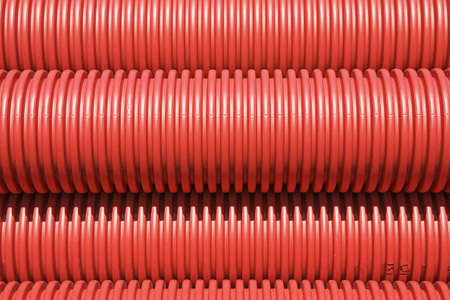 Red plastic pipes for the laying of underground power cablesの写真素材