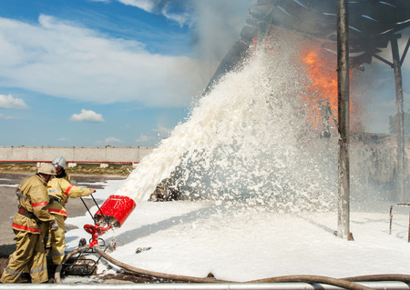 Firemen extinguish a house and building; の写真素材