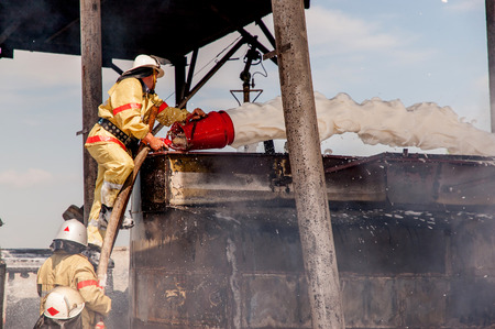 Firemen extinguish a house and building; の写真素材