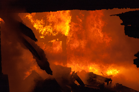 Fireman extinguish fire in homes and buildingsの写真素材