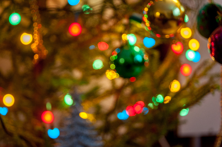 Pine branch with Christmas balls and fire in blur backgroundの写真素材