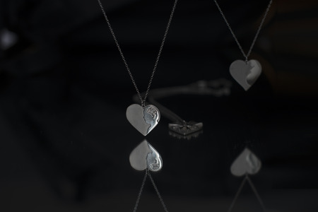 White silver necklace for women on black background with mirror reflectionの写真素材