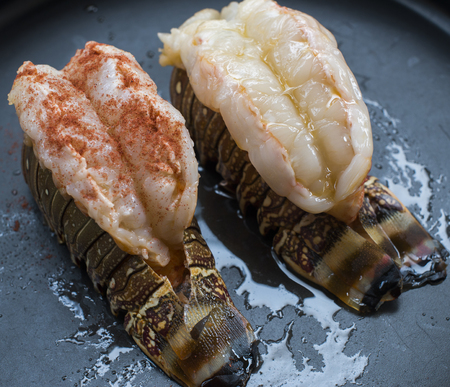 Raw lobster tail  food on a black backgroundの写真素材