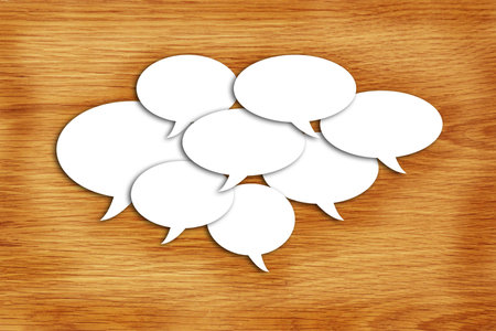paper speech bubbles on wood background 