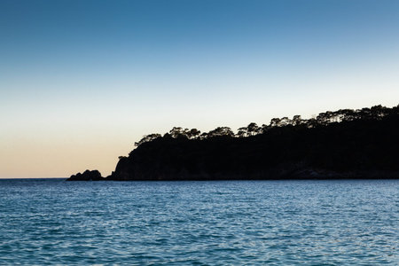 The sunset over the sea and mountains