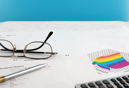 scientific report with glasses pen and calculating machine