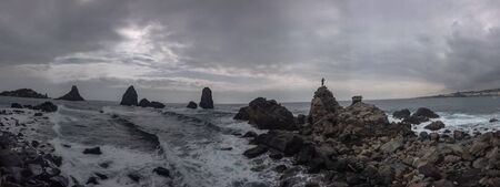 Lone man on a rock waiting the stormの写真素材
