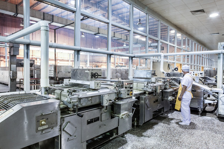 Workers in the food production factory Workers in the food production factory