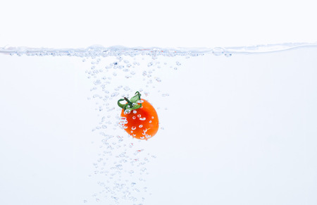 Strawberry falling into the waterの写真素材