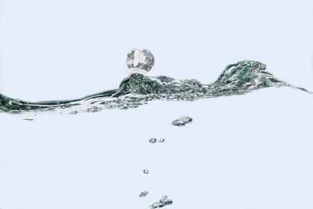 water wave with bubbles on white backgroundの写真素材