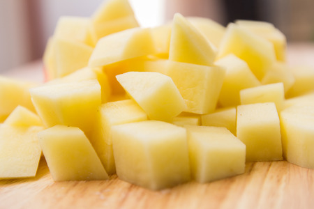 diced potatoes on a cutting boardの写真素材