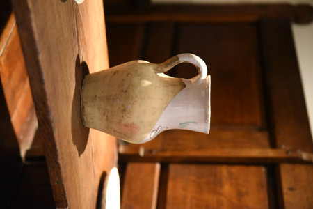 Old clay jug on top of an old wooden tableの写真素材