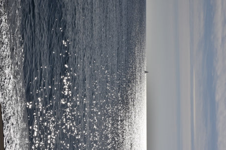 Sailboat in the distance at sea. Beautiful view on the water surface.の写真素材